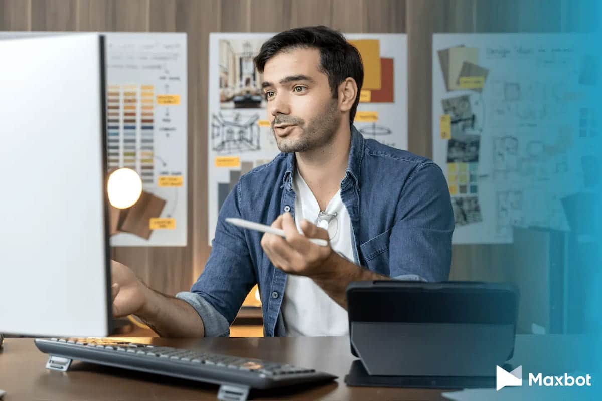 um homem sentado em uma mesa em frente a um computador